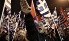 A Golden Dawn supporter raises his hand in a Nazi salute during a rally in Athens.