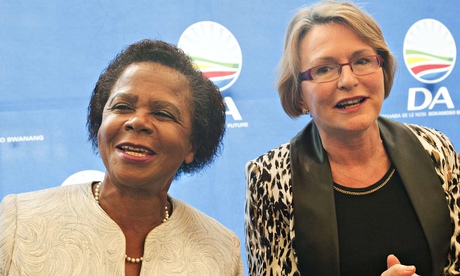 Mamphela Ramphele dances as she stands next to Helen Zille