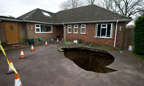 A sinkhole which swallowed a car on a driveway in High Wycombe, Buckinghamshire.