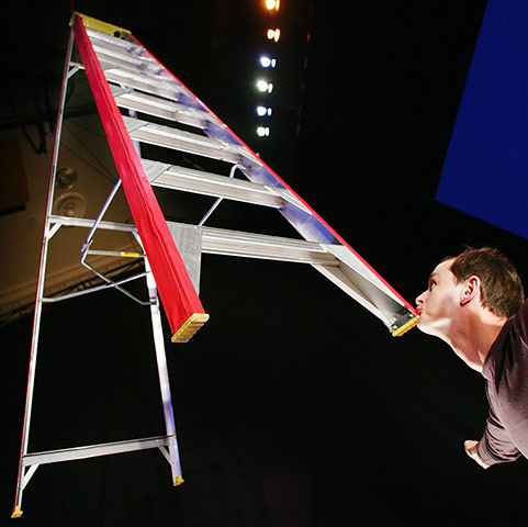 Circa: A performer balances a giant ladder 