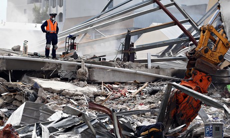 Rescue workers work on remains in Christchurch, New Zealand