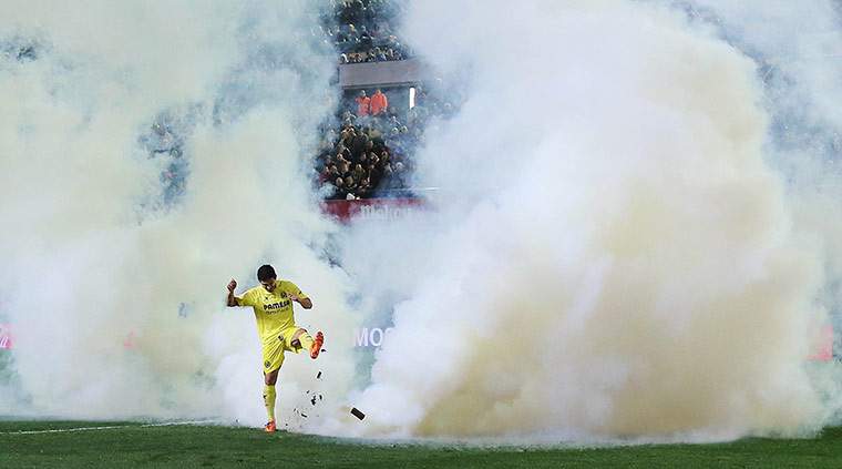 20 Photos: Villarreal's forward Jonathan Pereira kicks a smoke bomb at El Madrigal