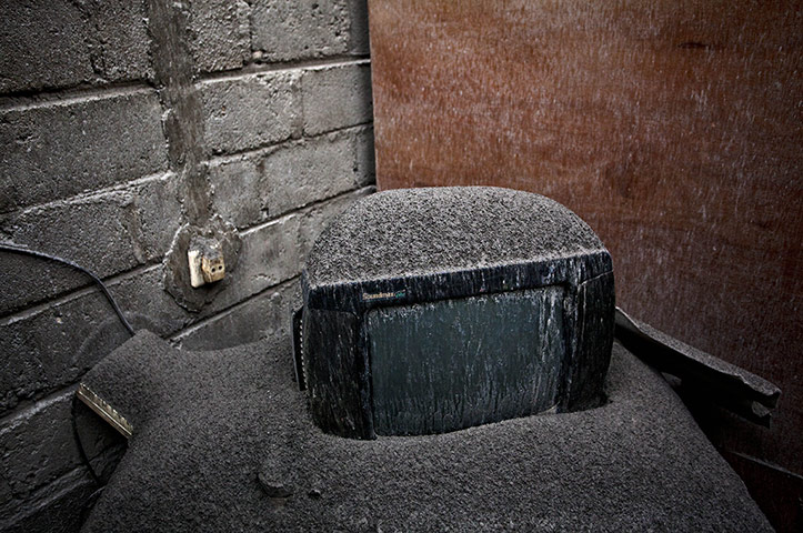 20 Photos: A television covered in ash from the eruptions of Mount Kelud in Indonesia