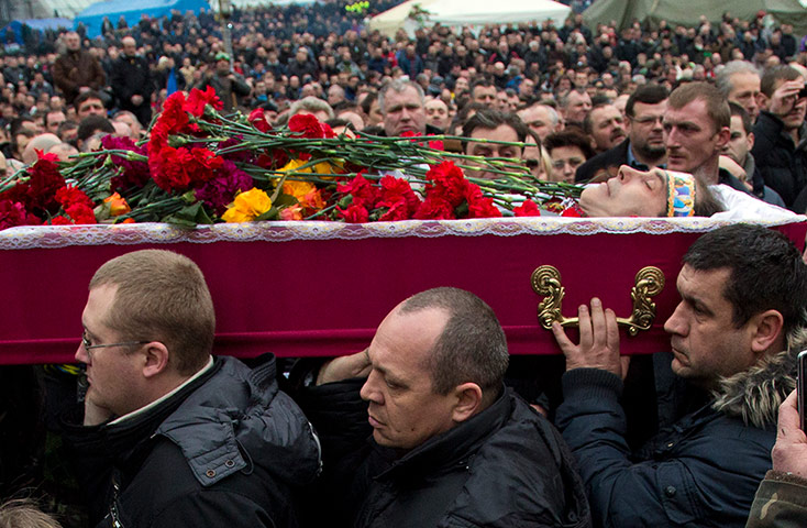 Kiev protests: A coffin carried through the crowd