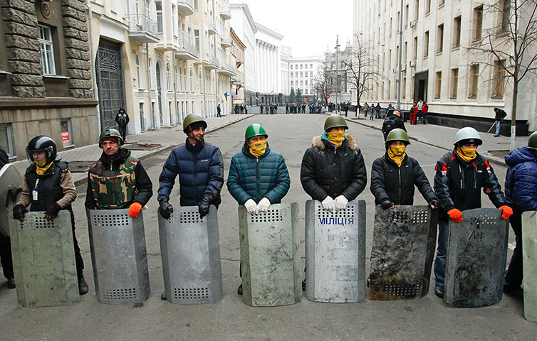 Kiev protests: Protesters guard a street leading to the presidential building