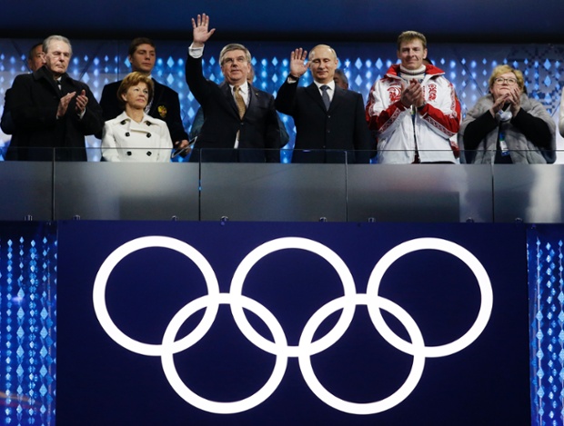 International Olympic Committee (IOC) President Thomas Bach, third from left, and Russian President Vladimir Putin, third from right, wave to spectators during the closing ceremony of the 2014 Winter Olympics in Sochi, Russia.