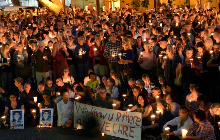 Light The Dark: People attend a candlelight vigil in Sydney on Sunday