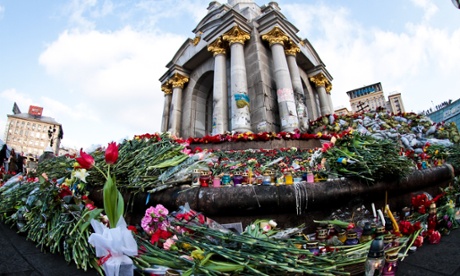 Flowers cover the foot of the independence monument in Kiev.