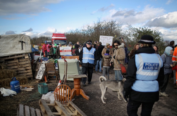 Police escort anti-fracking protestors as they walk in front of trucks leaving the Barton Moss gas fracking facility in Barton, England.