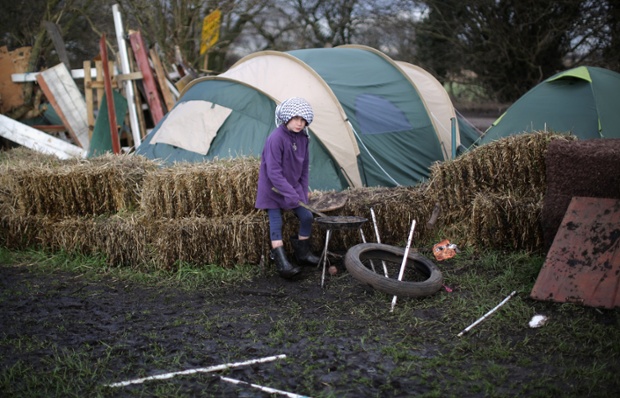A young girl plays amongst the tented village of anti-fracking campaigners near the Barton Moss exploration facility in Barton, England.