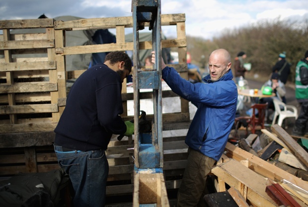 Anti-fracking campaigners strengthen their campsite from the elements near the Igas Barton Moss exploration facility in Barton, England.