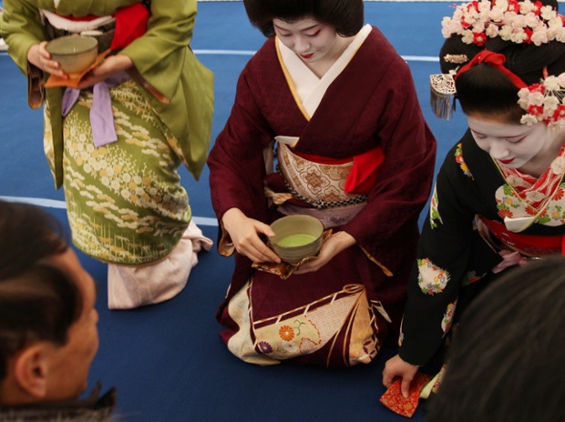 Japanese Geisha and Miok serve green tea for customers during the annual Baikasai, Plum Blossom Festival at Kitano Tenmangu Shrine on  in Kyoto, Japan.