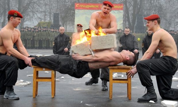 A Belarus Interior Ministry special forces soldier sustains a blow during a competition to mark the Defenders of the Fatherland Day at their training centre outside Minsk.
