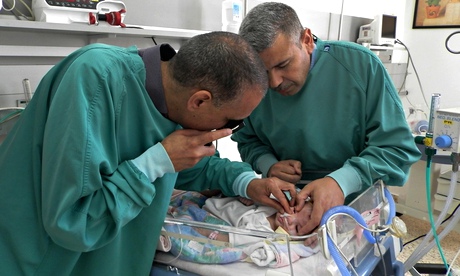 slam al-Hashash and a colleague treat a baby in West Bank eye unit 