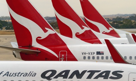 Qantas aeroplanes wait at Melbourne Tullamarine Airport on February 25, 2014 in Melbourne, Australia. On Thursday Qantas will announce their half year results, media reports suggest part of those announcements will include a large number of job cuts and the sale of their Melbourne terminal.
