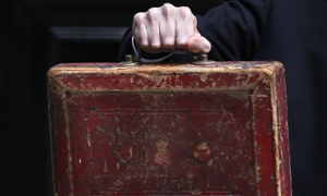 The hand of Chancellor of the Exchequer George Osborne carrying the famous old ministerial red box.