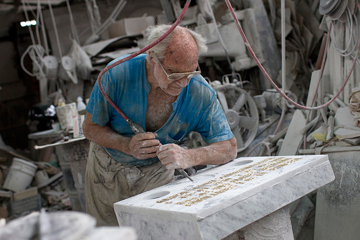 Caracas : Laudelino Morales chisels a tombstone at his factory near the Southern Ceme