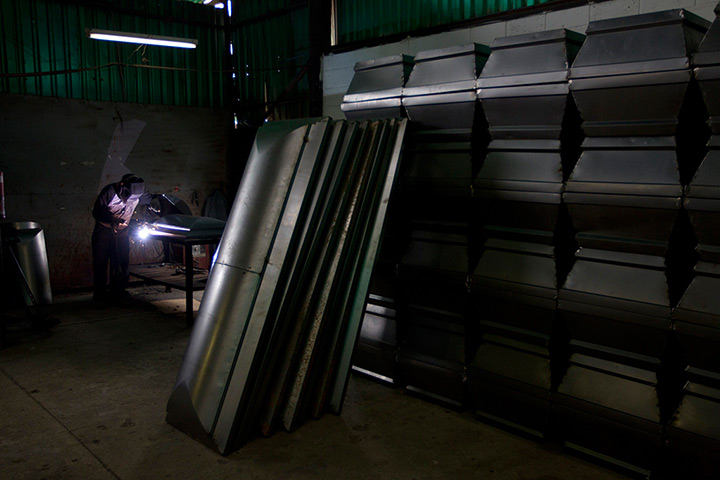 Caracas : A worker builds a coffin at a caskets factory 