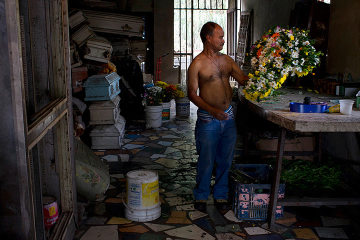 Caracas : Ponciano Capote makes a flower arrangement in an undertaker's flower shop