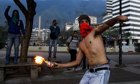 A  demonstrator throws an incendiary device during clashes with Venezuelan National Bolivarian Guard (GNB) during a protest against president Nicolas Maduro in Caracas, Venezuela. The   Venezuelan government accuses the opposition of attempting a coup d'etat to topple President Nicolas Maduro, who narrowly won election last year as the hand-picked successor to left-wing populist Hugo Chavez, who died in office March 2013.