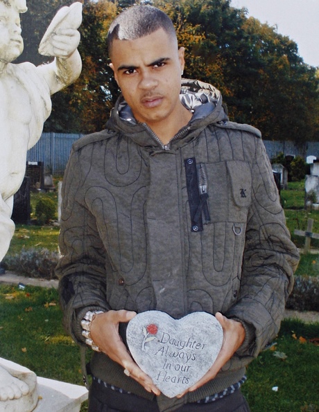 Mark Duggan, uncropped here to show him holding a memorial plaque for his stillborn child