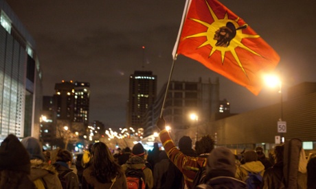 A man waves a Mohawk flag at a Montreal demonstration in support of the indigenous Idle No More movement in January, 2013.