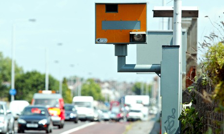 A yellow speed camera