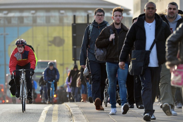 Pedestrians and cyclists cross Waterloo Bridge.