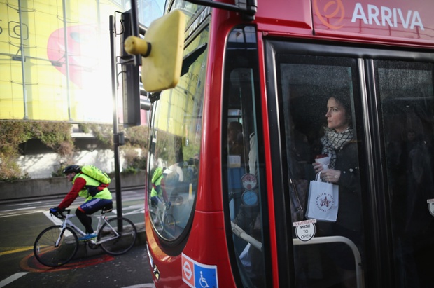 A packed bus travels past the IMAX cinema at Waterloo.