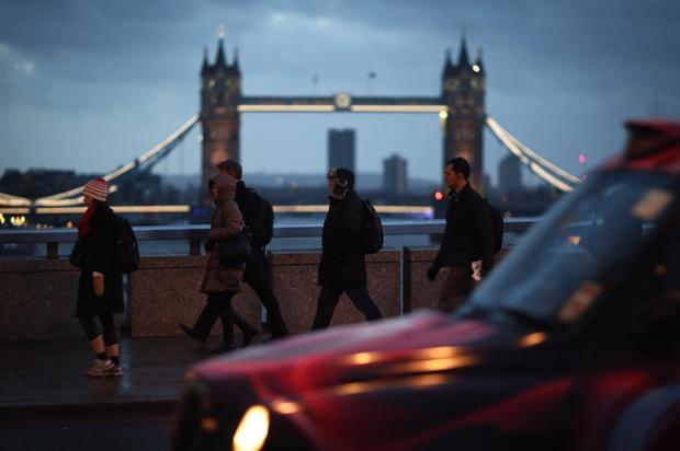 Pedestrians walk north across London Bridge.