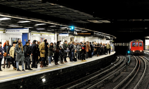 A train approaches the opposite platform on the District Line at Victoria.
