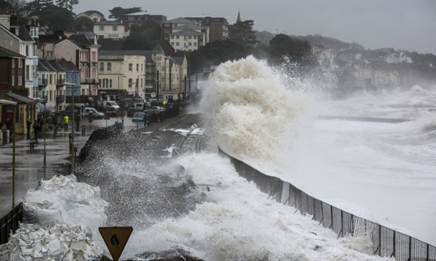 Waves crash against the seafront and the railway line that has been closed due to storm damage at Dawlish.
