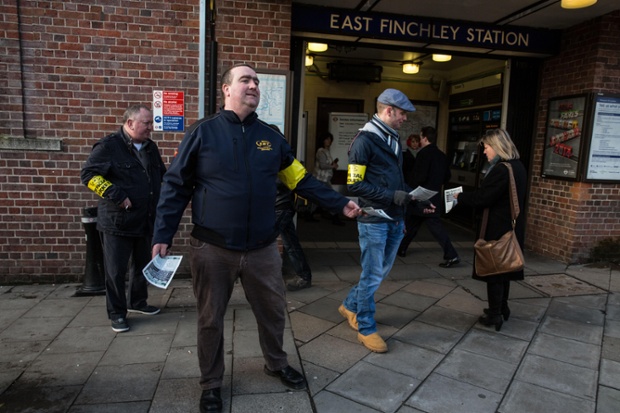 RMT union members hand out leaflets to the public explaining the reasons for the strike at East Finchley.
