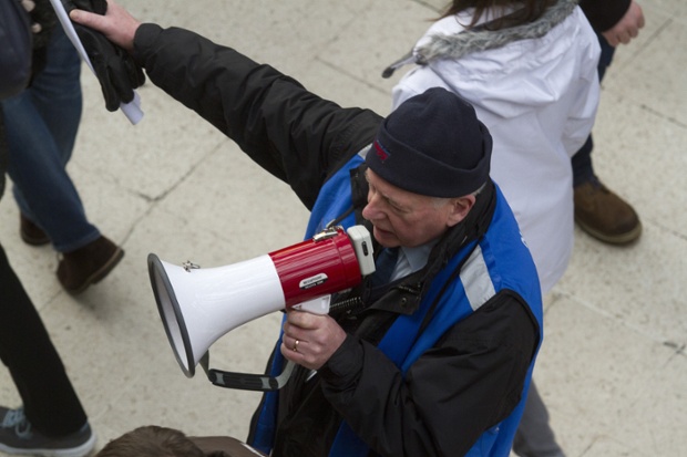 A staff member for Network Rail redirects customers at Waterloo.