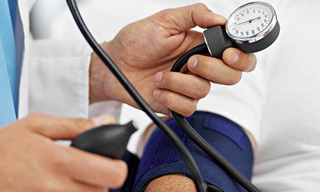 Doctor taking blood pressure of patient