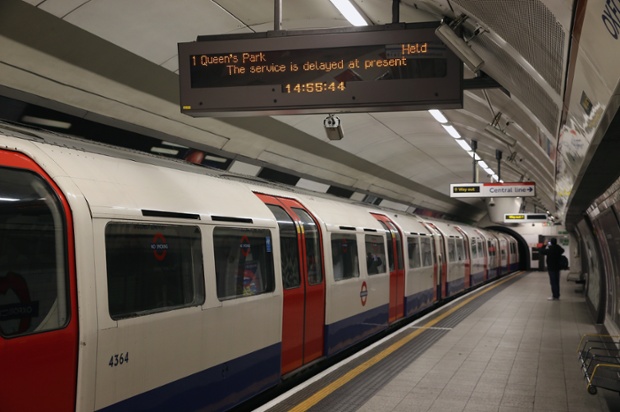 A Bakerloo line train sits idle on the Central line at Oxford Street.