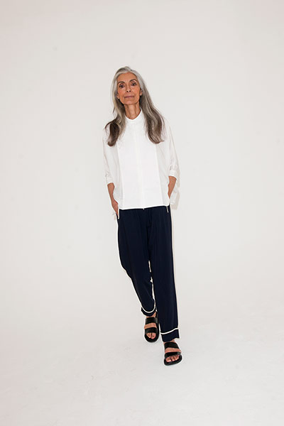 All Ages: white shirt loose black trousers with white trim at bottom sliders