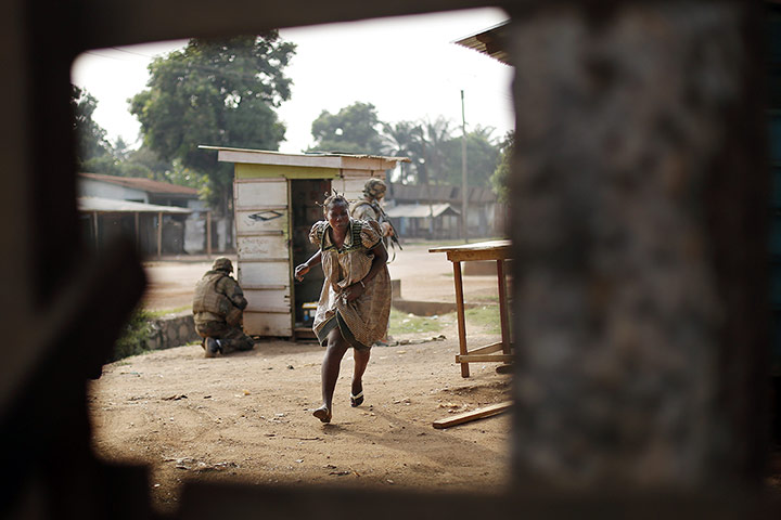 20 Photos: a woman runs for cover as heavy gunfire erupts in Bangui