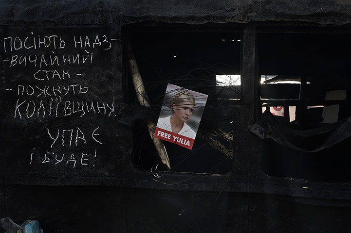 20 Photos: A picture of Yulia Tymoshenko is placed at a roadblock in Kiev