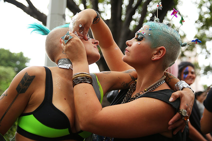 Mardi Gras: Mardi Gras Revellers decorate each other ahead of the parade