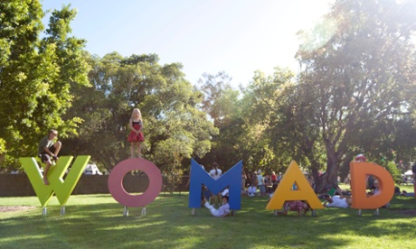 Children play on the Womad sign at Womaelaide 2014, held at the Botanic Gardens in the city.