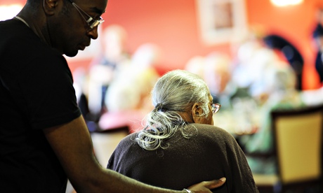 An elderly Sikh lady is helped 