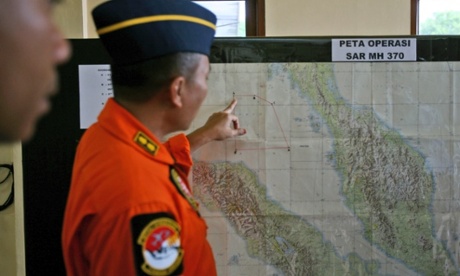 An Indonesia air force officer shows a map of Malacca Straits during a briefing prior to a search operation for the missing Malaysia Airlines Boeing 777.