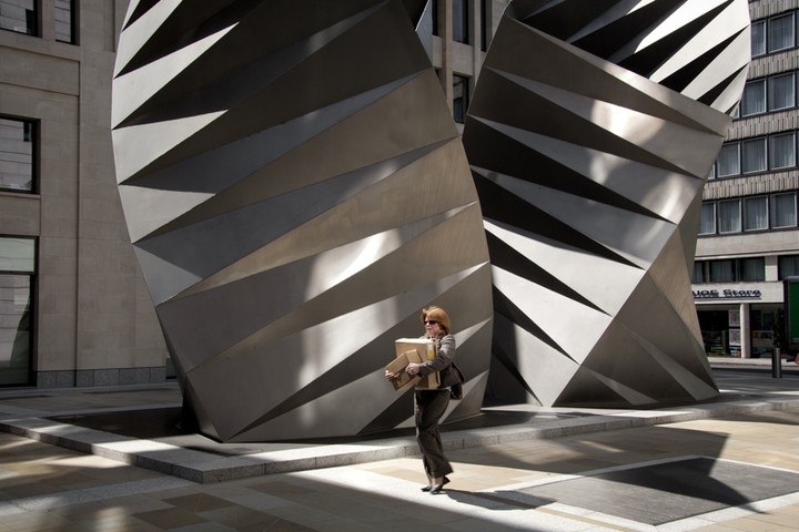 Big Picture: Square Mile: London's square mile. Woman carrying box in front of steel architecture