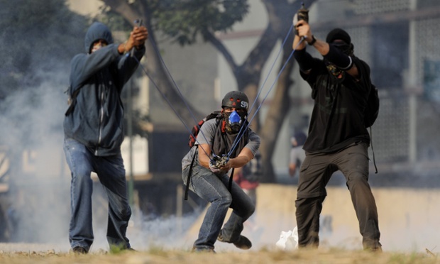 Opposition activists catapult stones with a slingshot during a protest against the government of Venezuelan President Nicolas Maduro, in Caracas.