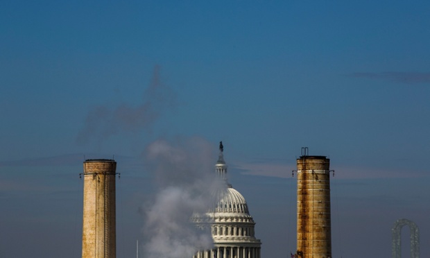 The dome of the US Capitol is seen behind the smokestacks of the Capitol Power Plant, the only coal-burning power plant in the nation's capitol, in Washington, DC.