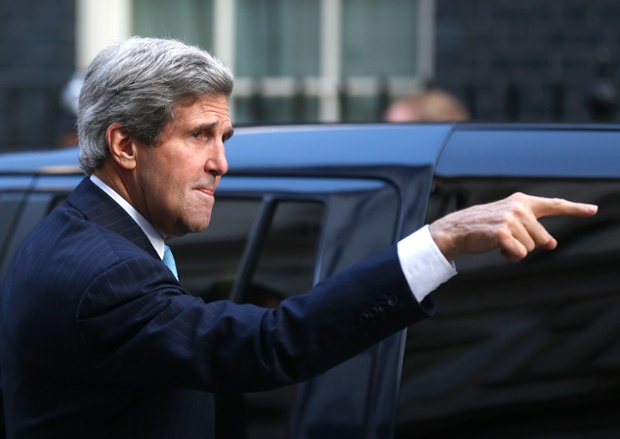 He gestures to his staff as he arrives for a meeting with David Cameron and William Hague in Downing street...