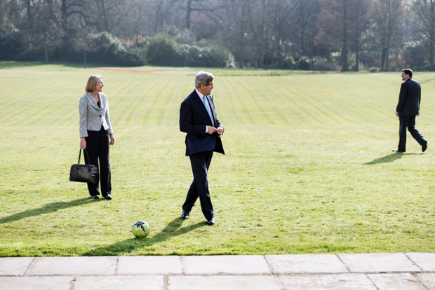 John Kerry enjoys the London sunshine as he waits for the arrival of Russian Foreign Minister Sergey Lavrov to arrive at Winfield House.