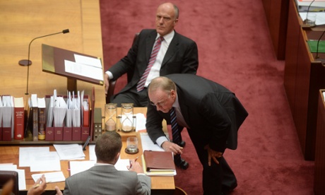 Liberal senator Ian McDonald speaks to the clerk in the Senate.