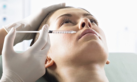 Woman Receiving Plastic Surgery Treatment in Her Lip With a Syringe